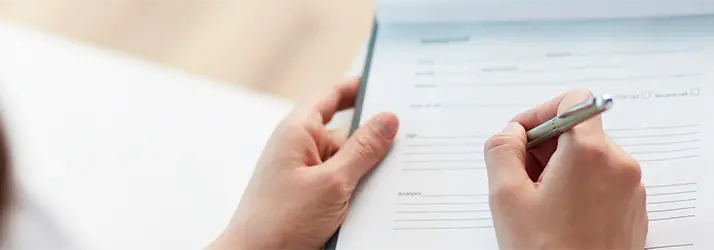 A person is filling out paperwork.