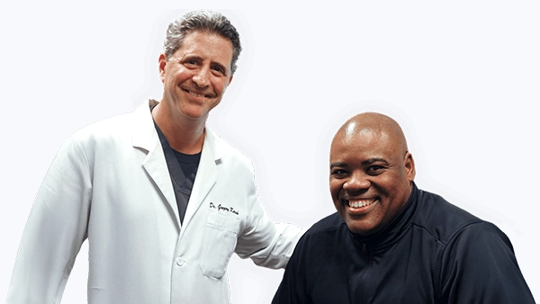 Gregory Kersh smiling with a patient.