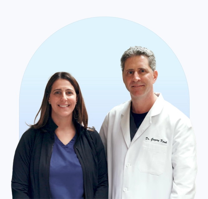 Robin L. Steinberg and Gregory Kersh smiling. There is a light blue arch behind them.